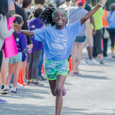Girls on the Run participant approaches the finish line at the 5K